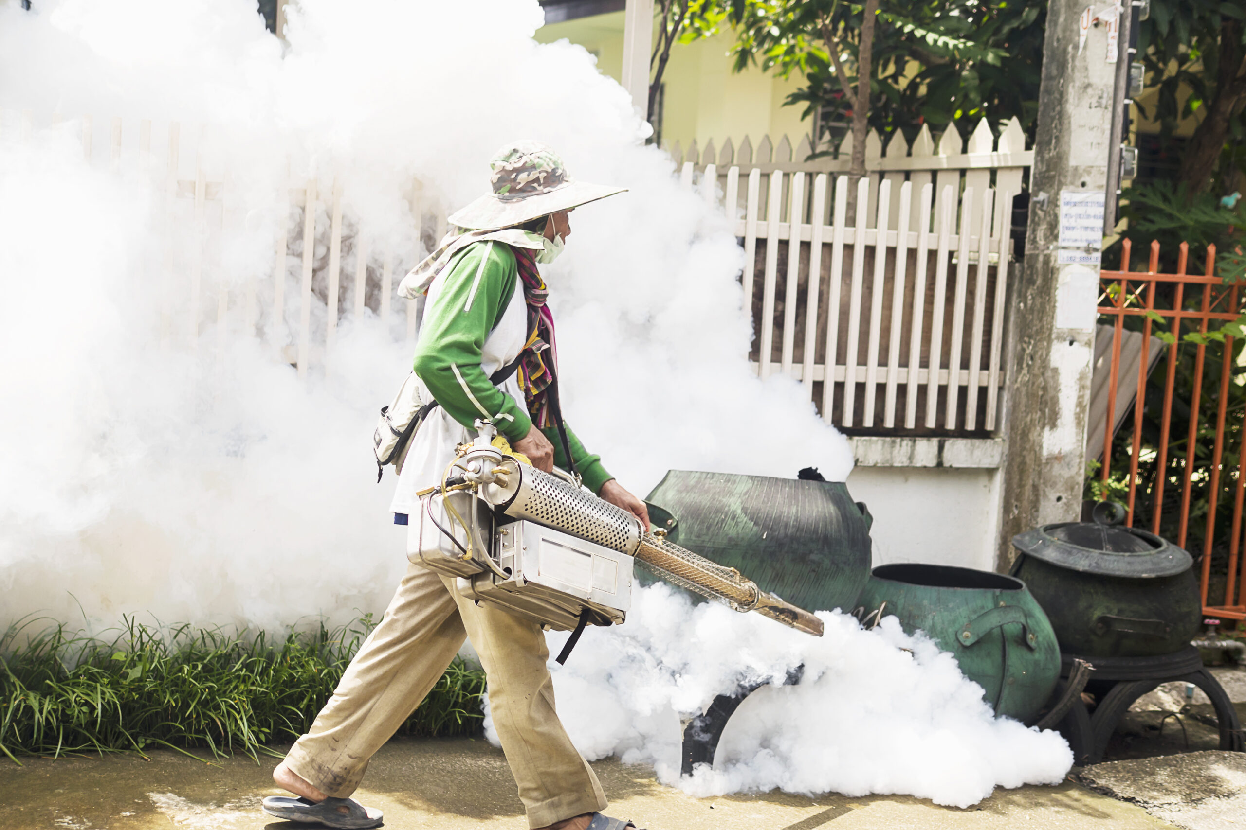 man is using thermal fog machine protect mosquito spreading scaled.jpg