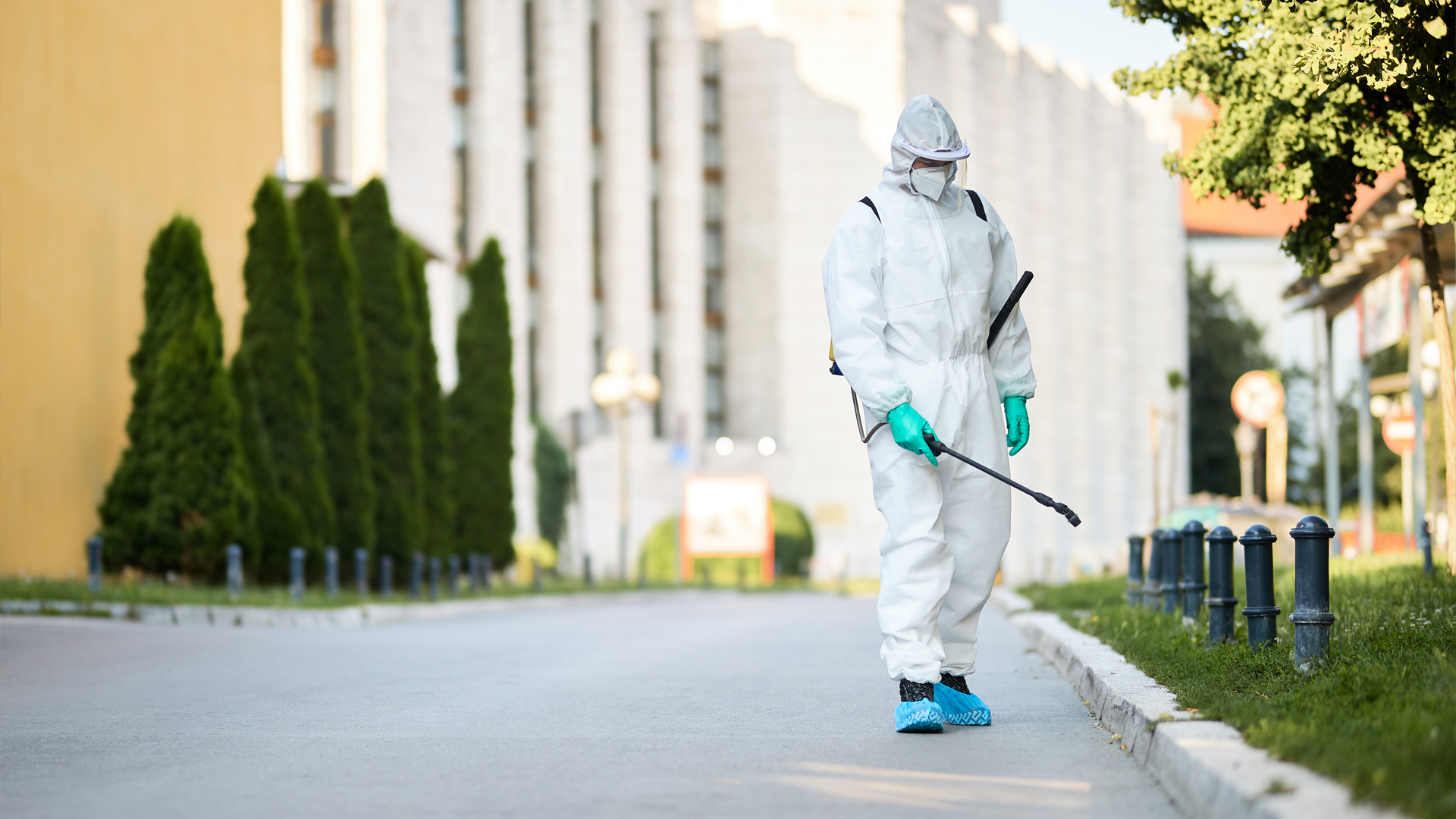 man protective suit disinfecting city streets coronavirus pandemic